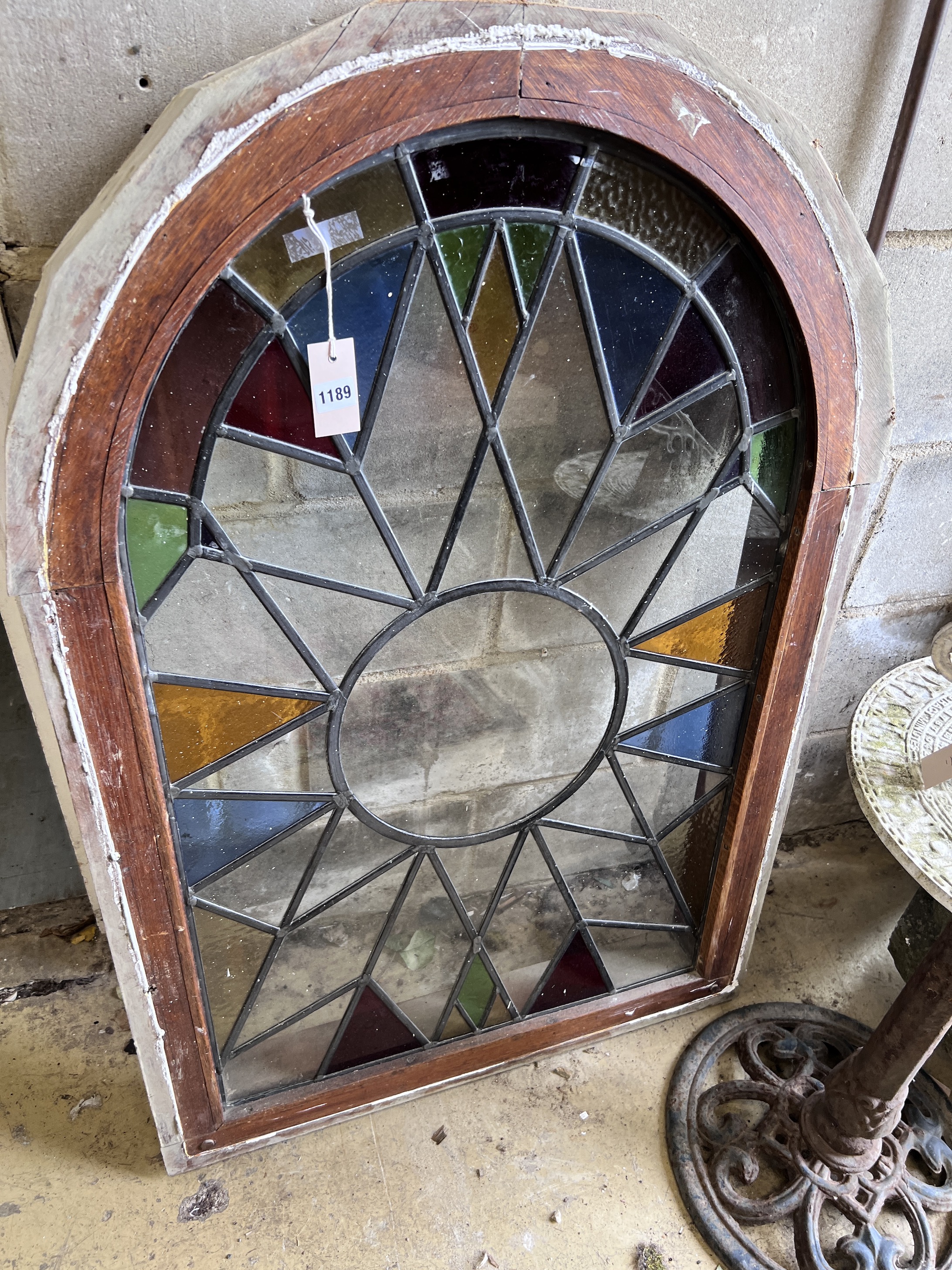 An arched stained glass window, height 110cm, width 76cm